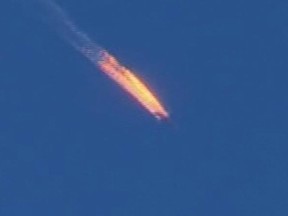 This frame grab from video by Haberturk TV, shows a Russian warplane on fire before crashing on a hill as seen from Hatay province, Turkey, Tuesday, Nov. 24, 2015. Turkey shot down the Russian warplane Tuesday, claiming it had violated Turkish airspace and ignored repeated warnings. Russia denied that the plane crossed the Syrian border into Turkish skies. (Haberturk TV via AP)  TURKEY OUT ORG XMIT: POS1511260458430596