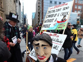 This is one of many messages participants bring as thousands of people gather for a march to rally on Parliament Hill, on Sunday, Nov. 29, 2015, in Ottawa, against climate change on a day when multiple cities globally saw protests and demonstrations in the lead-up to the United Nations Climate Change Conference in Paris, France.