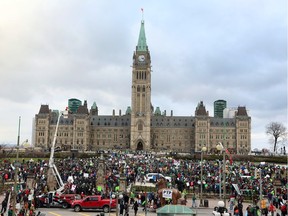 Thousands of people gather for a rally on Parliament Hill, on Sunday, Nov. 29, 2015, in Ottawa, against climate change on a day when multiple cities globally saw protests and demonstrations in the lead-up to the United Nations Climate Change Conference in Paris, France.