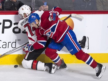 Ottawa Senators' Mark Borowiecki, left, is crushed into the boards by Montreal Canadiens' Tomas Plekanec during second period NHL action.