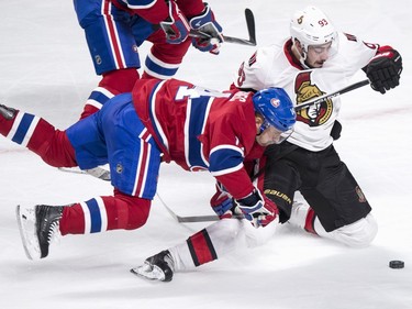 Montreal Canadiens' Tomas Plekanec, left, falls during a challenge to Ottawa Senators' Mika Zibanejad for the puck during third period NHL hockey action, in Montreal, on Tuesday, Nov. 3, 2015.