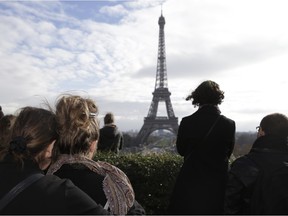 People observe a minute of silence at the Place de Trocadero in Paris on November 16, 2015 to pay tribute to victims of the attacks claimed by Islamic State, which killed at least 129 people and left more than 350 injured on November 13.