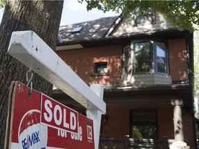 A house with a for sale sign indicating it was sold as seen in Toronto, ON Tuesday, June 23, 2015.