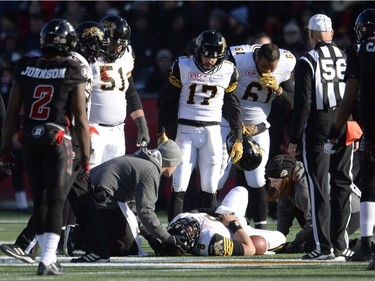 Trainers attend to Hamilton Tiger-Cats quarterback Jeremiah Masoli (8) after he was hit while running the ball during first half action against the Ottawa Redblacks in the CFL East Division final in Ottawa, Sunday November 22, 2015.