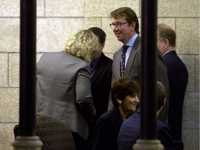 Treasury Board President Scott Brison, centre, makes his way to a meeting a cabinet on Parliament Hill, in Ottawa, Thursday November 12, 2015.