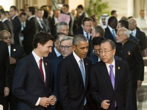 US President Barack Obama walks alongside UN Secretary General Ban Ki-Moon (R), Canadian Prime Minister Justin Trudeau (L) and other world leaders as they arrive for the official family photo during the G20 summit in Antalya, Turkey, November 15, 2015.