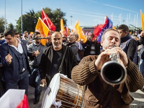 Musicians play music as supporters wait for the Turkish Prime Minister Ahmet Davutoglu at the Istanbul Ataturk airport on November 3, 2015 in Istanbul. Turkey's long dominant Justice and Development Party (AKP) scored a stunning election success at the weekend with a vote that returned it to single-party rule after months of political uncertainty.