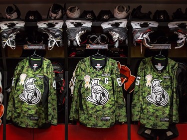 Camouflage warmup jerseys hang in the Ottawa Senators dressing room on Canadian Forces Appreciation Night prior to the game.