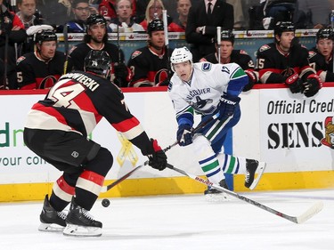 zOTTAWA, ON - NOVEMBER 12: Radim Vrbata #17 of the Vancouver Canucks stickhandles the puck against Mark Borowiecki #74 of the Ottawa Senators during an NHL game at Canadian Tire Centre on November 12, 2015 in Ottawa, Ontario, Canada.