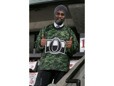 The newly appointed Canadian Minister of National Defence, The Honourable Harjit Sajjan hams it up while wearing a Sens Camouflage jersey.