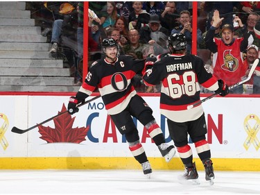 Erik Karlsson #65 of the Ottawa Senators celebrates his second period goal with team mate Mike Hoffman #68.