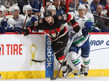 Alex Chiasson #90 of the Ottawa Senators skates into the offensive zone ahead of Yannick Weber #6 of the Vancouver Canucks.