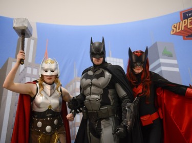 Volunteers from The League of Super Heroes dressed up as super heroes pose for a photo at Pop Expo on Saturday, Nov. 21, 2015. Volunteers took photo with the fans to raise fund for CHEO.