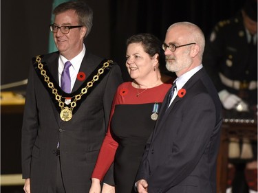 Wendy Muckle receives the Order of Ottawa from Mayor Jim Watson and Councillor Jeff Leiper at City Hall in Ottawa on Tuesday, November 10, 2015.