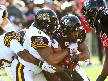 William Powell of the Ottawa Redblacks is tackled by Bryan Hall of the Hamilton Tiger-Cats during first half of the East Conference finals at TD Place in Ottawa, November 22, 2015. (Jean Levac/ Ottawa Citizen)