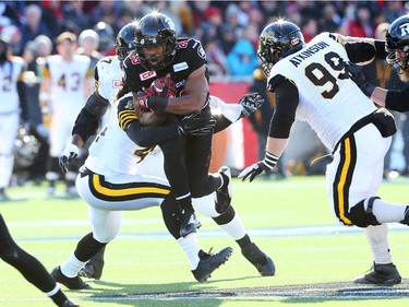 William Powell of the Ottawa Redblacks is tackled by the Hamilton Tiger-Cats during first half of the East Conference finals at TD Place in Ottawa, November 22, 2015. (Jean Levac/ Ottawa Citizen)