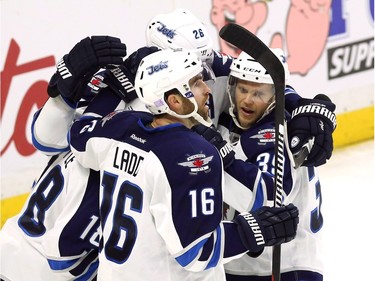 Winnipeg Jets' Andrew Ladd (16) celebrates his goal with teammates Toby Enstrom (39) and Blake Wheeler (26) during second period NHL hockey action, in Ottawa, on Thursday, Nov. 5, 2015.