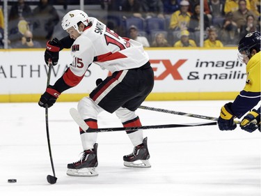 Ottawa Senators center Zack Smith (15) gets past Nashville Predators forward Mike Fisher, right, as Smith shoots and scores his second goal during the first period.
