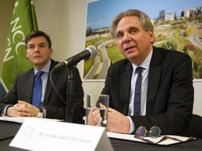The National Capital Commission's Pierre Lanctot, executive director of corporate services, left, looks on as Mark Kristmanson, NCC CEO, speaks during a press conference to announce the shortlist of developers for Lebreton Flats Wednesday February 18, 2015. (Darren Brown/Ottawa Citizen)