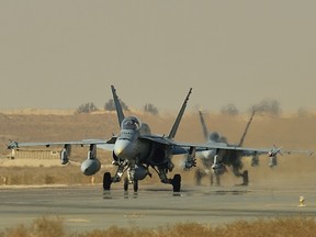 Royal Canadian Air Force CF-18 fighter jets taxi on the runway in Kuwait during Operation IMPACT on November 13, 2014.