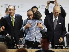 Executive Secretary of the United Nations Framework Convention on Climate Change (UNFCCC) Christiana Figueres (C-R) and France's President Francois Hollande (C-L) hug after the adoption of a historic global warming pact at the COP21 Climate Conference in Le Bourget, north of Paris, on December 12, 2015. Envoys from 195 nations on December 12 adopted to cheers and tears a historic accord to stop global warming, which threatens humanity with rising seas and worsening droughts, floods and storms. AFP PHOTO / FRANCOIS GUILLOT FRANCOIS GUILLOT/AFP/Getty Images