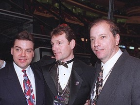 Bruce Firestone, at right, poses for a picture with Randy Sexton, left, and Cyril Leeder