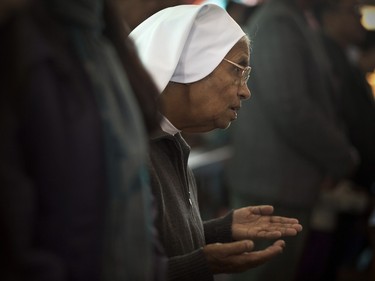 A Christian nun offers prayers on Christmas in Gauhati, India, Friday, Dec. 25, 2015. Though Hindus and Muslims comprise the majority of the population in India, Christmas is a national holiday celebrated with much fanfare.