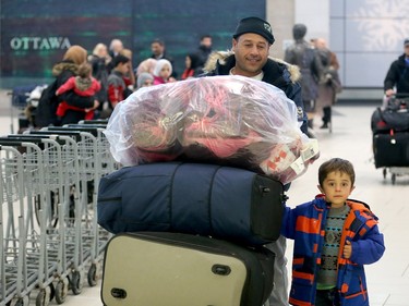 A couple of dozen Syrian refugees, who seemed tired but happy,  arrived at Ottawa's airport Tuesday (Dec. 29, 2015) to a welcoming group of volunteers handing out gifts. The group was taken from the airport in a bus to downtown, but not before feeling the chill of the capital's first winter snowstorm.