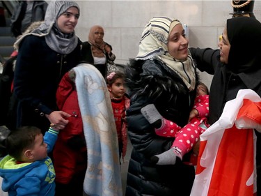 A couple of dozen Syrian refugees, who seemed tired but happy,  arrived at Ottawa's airport Tuesday (Dec. 29, 2015) to a welcoming group of volunteers handing out gifts. The group was taken from the airport in a bus to downtown, but not before feeling the chill of the capital's first winter snowstorm.
