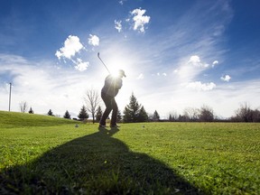 A golfer tees off at Falcon Ridge Golf Club.