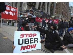 About 250 taxi drivers block the intersection of Queen and Bay Sts. to protest Uber on Wednesday December 9, 2015. Veronica Henri/Toronto Sun/Postmedia Network