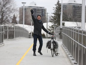 The new Adawe Crossing bridge opened up early in Ottawa Ontario Friday Dec 4, 2015. The pedestrian and cycling bridge which goes over the Rideau River connects between Donald Street and Somerset Street Wast in Ottawa. Ottawa City Councillor Toby Nussbaum waves while crossing the bridge Friday.  Tony Caldwell/Ottawa Sun/Postmedia Network