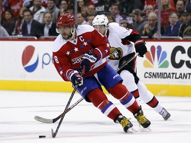 Washington Capitals left wing Alex Ovechkin (8), from Russia, skates with the puck with Ottawa Senators right wing Bobby Ryan (6) behind, during the second period.