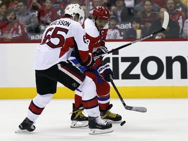 Washington Capitals left wing Alex Ovechkin (8), from Russia, skates with the puck as Ottawa Senators defenceman Erik Karlsson (65), from Sweden, defends during the first period.