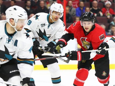 Bobby Ryan of the Ottawa Senators is tangled by Marc-Edouard Vlasic, left, Dainius Zubrus (9) of the San Jose Sharks during first period NHL action.