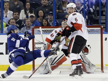 Tampa Bay Lightning center Brian Boyle (11) gets tripped up by Ottawa Senators right wing Bobby Ryan (6) in front of goalie Craig Anderson during the first period.