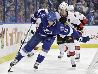 Tampa Bay Lightning center Brian Boyle (11) pushes off Ottawa Senators center Kyle Turris (7) as he skates behind the goal during the second period.
