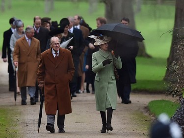 Britain's Phince Philip, the Duke of Edinburgh (L) and Britain's Princess Anne, Princess Royal (R) walk ahead of other members of the royal family for a traditional Christmas Day Church Service at Sandringham in eastern England, on December 25, 2015.