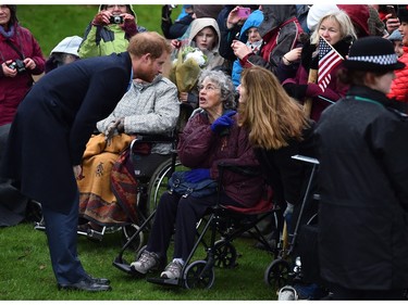 Britain's Prince Harry (L) greets wellwishers after attending a traditional Christmas Day Church Service at Sandringham in eastern England, on December 25, 2015.
