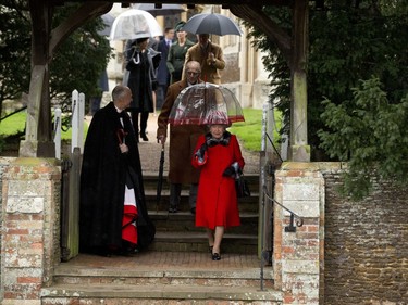 Britain's Queen Elizabeth II and her husband Prince Philip, behind her, leave after attending the British royal family's traditional Christmas Day church service at St. Mary Magdalene Church in Sandringham, England, Friday, Dec. 25, 2015.