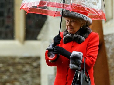 Britain's Queen Elizabeth II shelters under an umbrella as she leaves, after attending the British royal family's traditional Christmas Day church service at St. Mary Magdalene Church in Sandringham, England, Friday, Dec. 25, 2015.