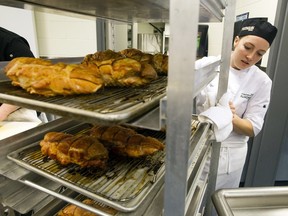 A culinary management student at Algonquin College, carts some cooked turkey breasts through the kitchen during Operation Big Turkey prep last Christmas