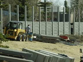 A noise barrier rises alongside a busy roadway in Calgary.