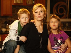 Caroline Pomeroy and her two youngest kids, Jack, 7, and Lila 9, pose for a photo in their home in Ottawa on Thursday December 10, 2015. The kids will be suspended from school next week unless they get certain vaccinations or their mother obtains a statement of conscience to prove her objections.