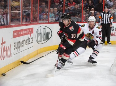 Shane Prince #10 of the Ottawa Senators controls the puck behind the net against Duncan Keith #2 of the Chicago Blackhawks.