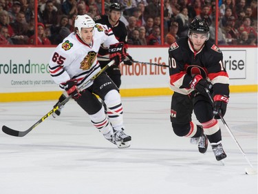 Shane Prince #10 of the Ottawa Senators stickhandles the puck across the blue line against Andrew Shaw #65 of the Chicago Blackhawks.