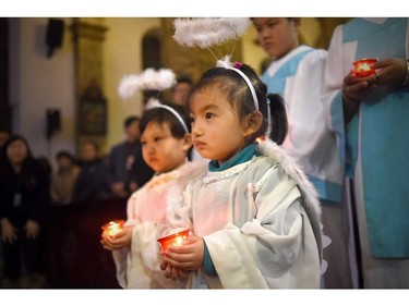 Young Chinese worshippers attend the Christmas Eve mass at a Catholic church in Beijing on December 24, 2015 as Christians around the world prepare to celebrate the holy day.