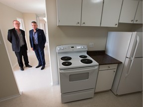 Chris Hawley, left, and John Lago of Q Residential stand in one of the apartments their company is offering to rent to Syrian refugees on Donald Street.