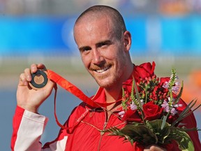 Canada's Thomas Hall of Pointe Claire, Qc. holds up his bronze medal in the men's C-1 1000 meter race at the Shunyi Rowing-Canoeing Park at the Olympic Games in Beijing August 22, 2008.