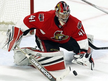 Ottawa Senators goalie Craig Anderson reaches for a loose puck against the Boston Bruins on Sunday, Dec. 28, 2015. Anderson made 38 saves in a 3-1 win.